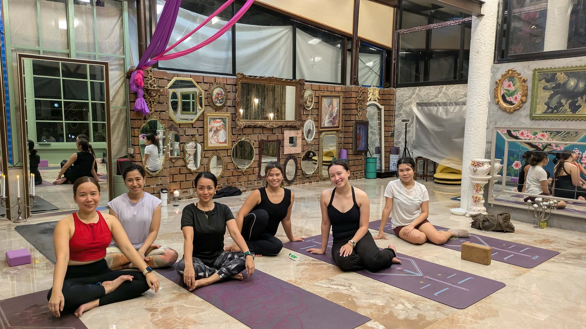 Yoga teacher guiding students with mindfulness and self-inquiry beyond physical fitness